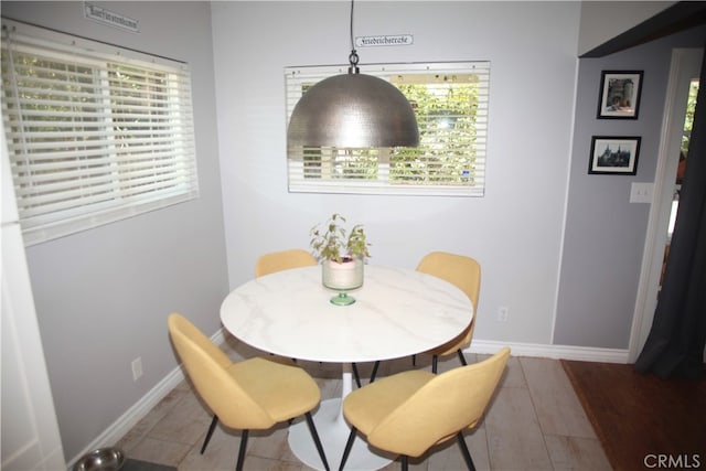 dining space with hardwood / wood-style floors