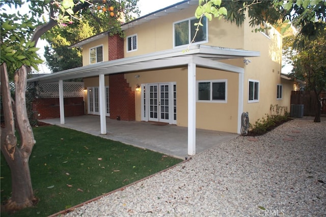 back of house with cooling unit, french doors, and a patio area