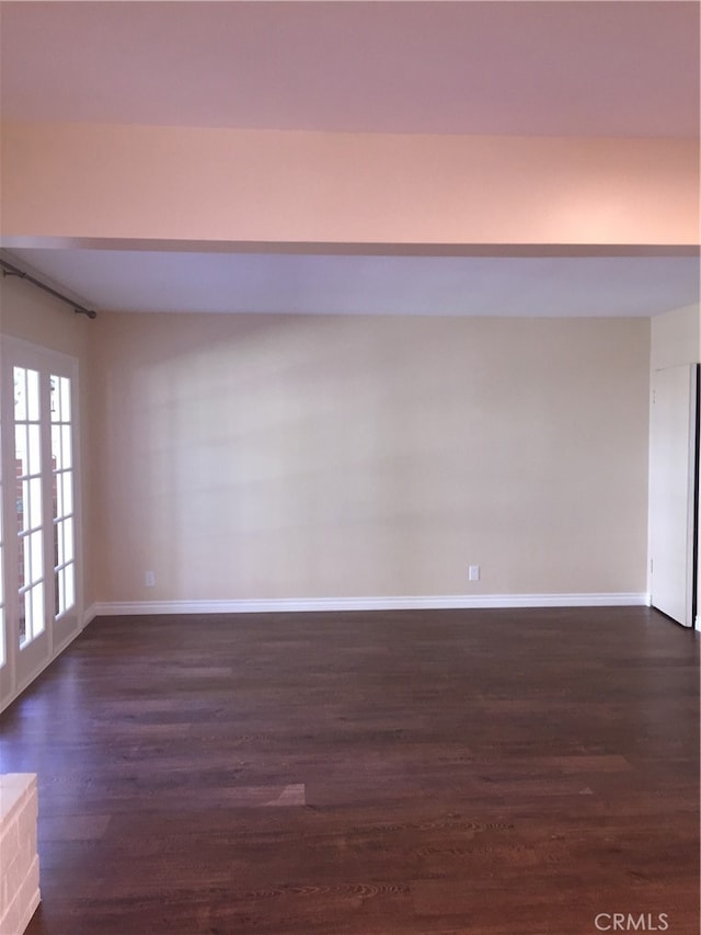 empty room featuring dark wood-type flooring