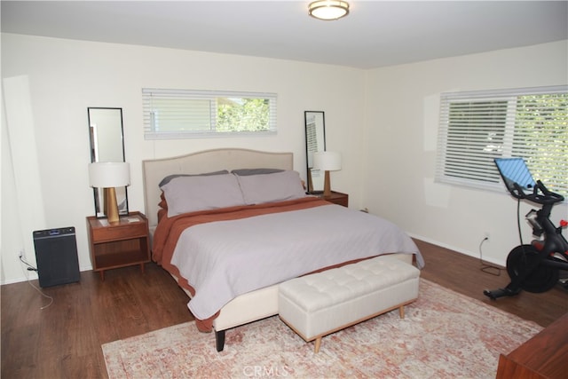 bedroom with dark hardwood / wood-style floors