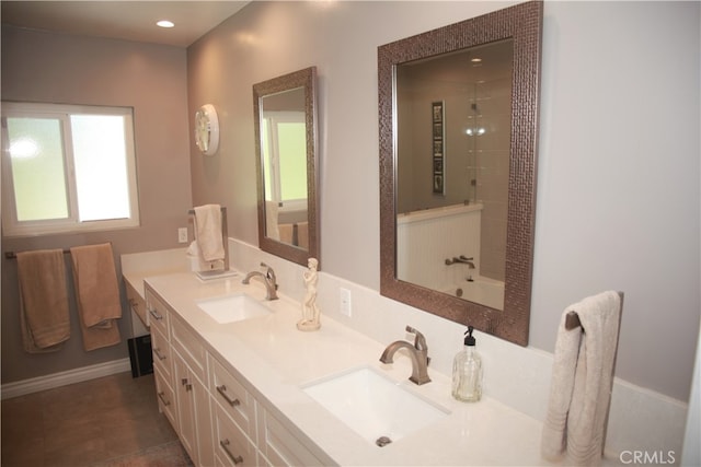 bathroom with a tile shower, tile patterned flooring, and vanity