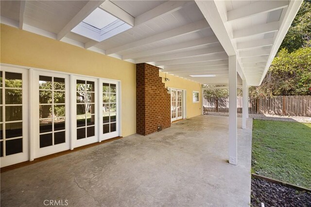 view of patio featuring fence and french doors