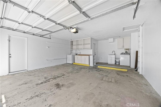 garage featuring a garage door opener and independent washer and dryer