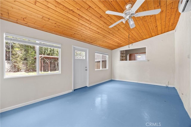 empty room featuring concrete floors, a ceiling fan, a wall mounted AC, wood ceiling, and baseboards