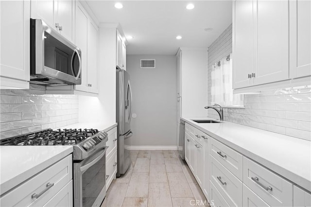 kitchen with visible vents, a sink, recessed lighting, and appliances with stainless steel finishes