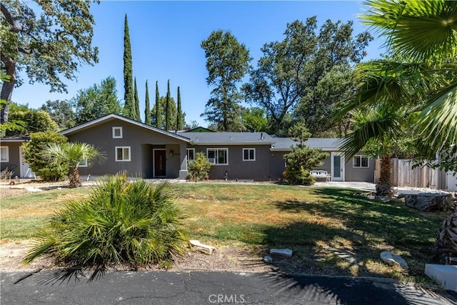 ranch-style home featuring a front yard