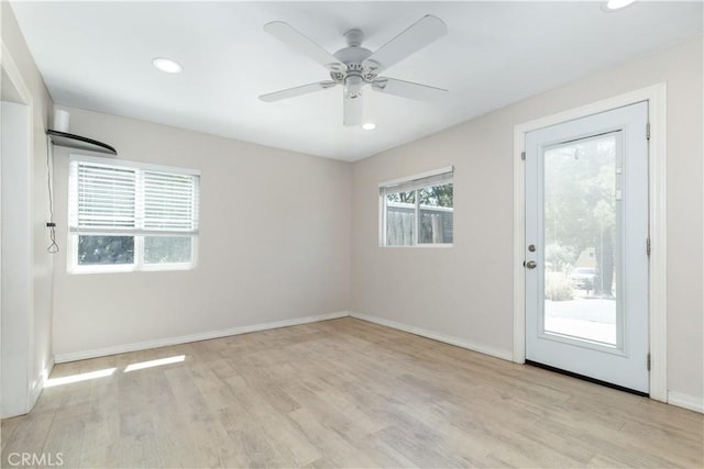 unfurnished room featuring ceiling fan, plenty of natural light, and light wood-type flooring