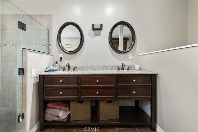 bathroom with an enclosed shower, vanity, and tile patterned flooring