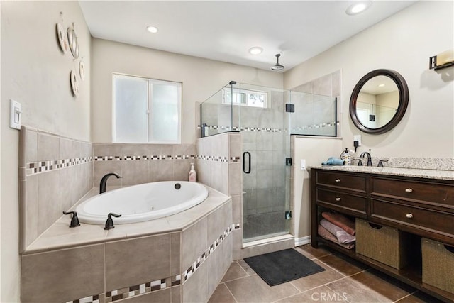 bathroom with independent shower and bath, tile patterned floors, and vanity