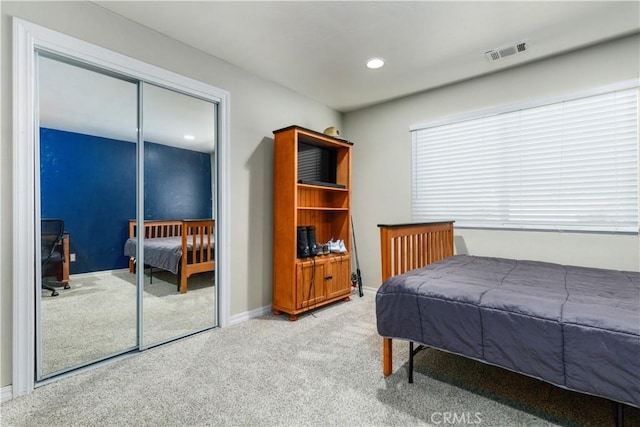 carpeted bedroom with a closet