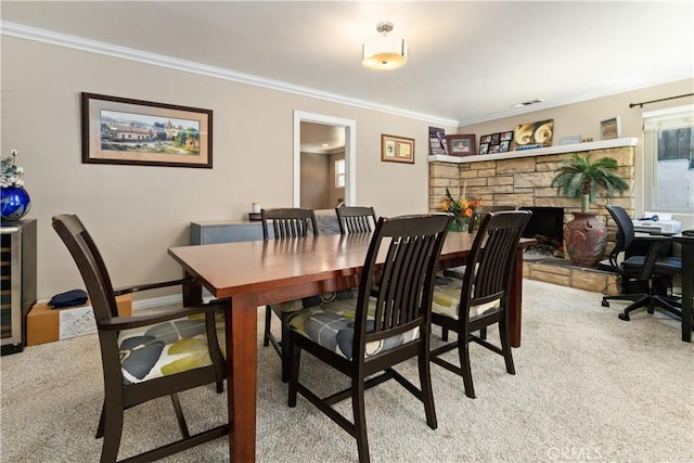 carpeted dining space featuring a fireplace and ornamental molding