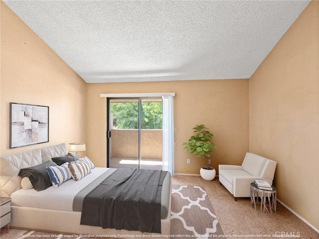 carpeted bedroom featuring access to outside and a textured ceiling