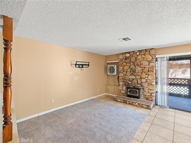 unfurnished living room with light tile patterned floors and a textured ceiling