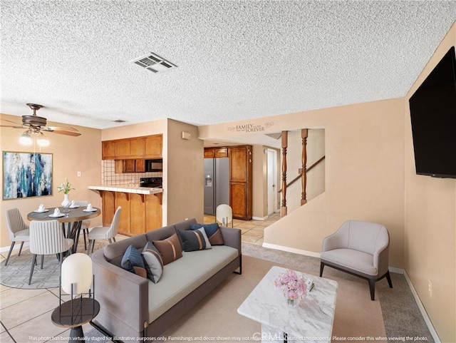 living room featuring light tile patterned floors and ceiling fan