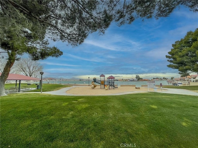 view of jungle gym with a yard and a water view