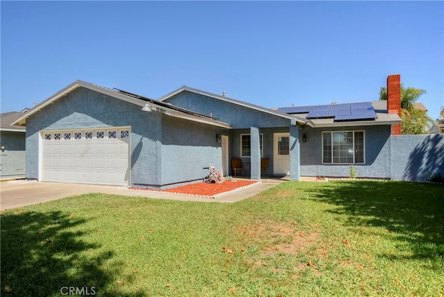 ranch-style house with a front lawn, solar panels, and a garage