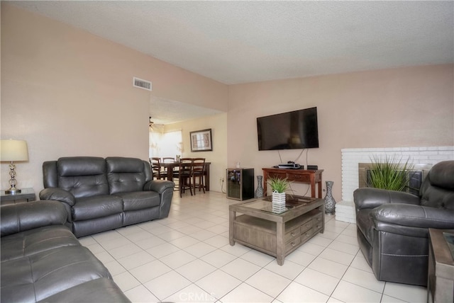 living room featuring a textured ceiling and light tile patterned flooring