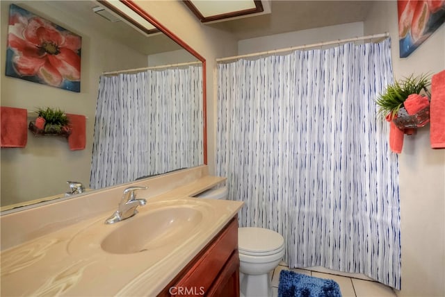 bathroom with vanity, tile patterned flooring, and toilet