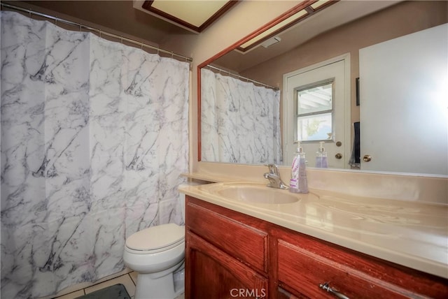 bathroom with tile walls, tile patterned floors, vanity, and toilet