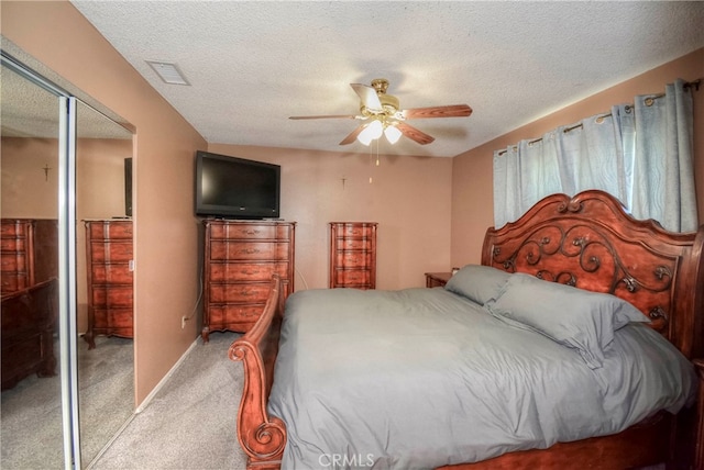 bedroom with a textured ceiling, ceiling fan, and a closet