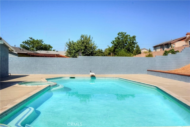 view of swimming pool with an in ground hot tub