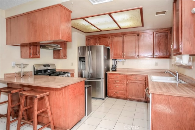 kitchen with a breakfast bar, sink, kitchen peninsula, appliances with stainless steel finishes, and extractor fan