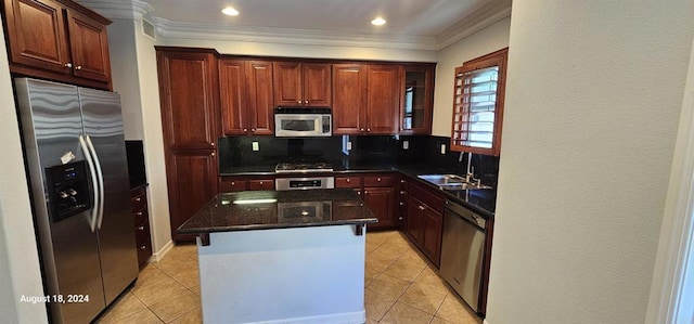 kitchen featuring tasteful backsplash, stainless steel appliances, sink, a kitchen island, and light tile patterned flooring