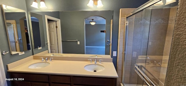 bathroom featuring plus walk in shower and vanity