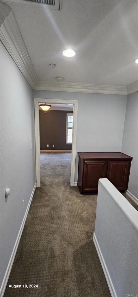 hallway with carpet flooring and ornamental molding