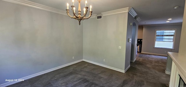 empty room featuring dark carpet, crown molding, and a chandelier