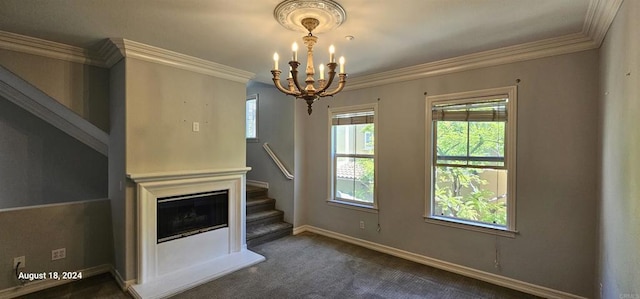 unfurnished living room with dark colored carpet, a notable chandelier, and ornamental molding