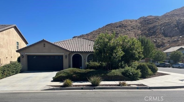 view of front facade with a mountain view and a garage