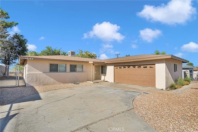 single story home with central AC and a garage