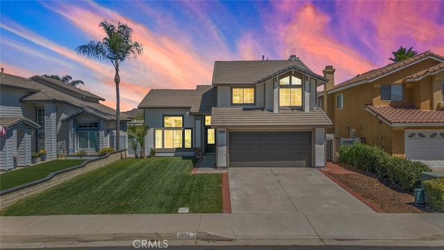 view of front of home featuring a garage and a lawn