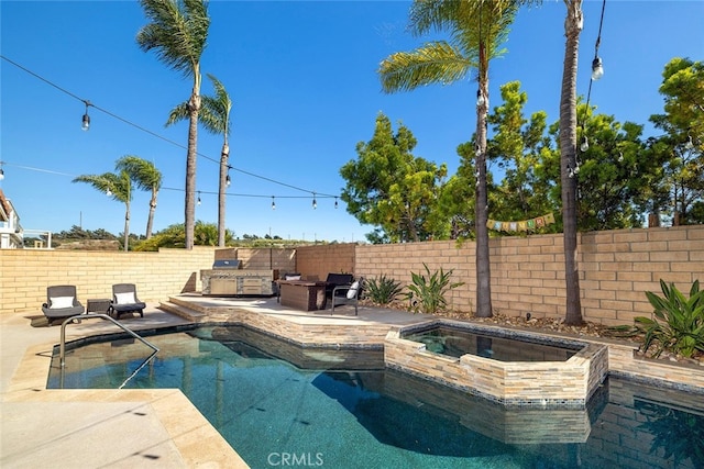 view of swimming pool with an outdoor kitchen, a patio area, and an in ground hot tub