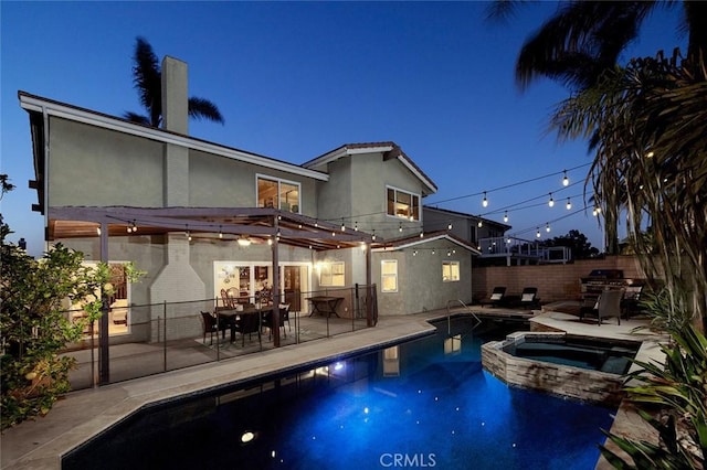 view of pool with a patio area and an in ground hot tub