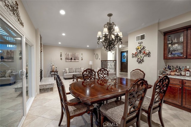 dining space with a chandelier, light tile patterned floors, and ornamental molding