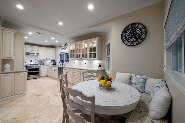 kitchen featuring backsplash, sink, ornamental molding, and appliances with stainless steel finishes