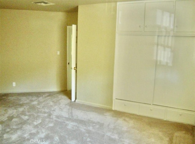 unfurnished room with light carpet