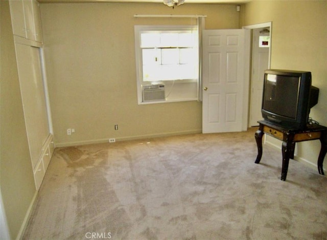 misc room with light colored carpet and an AC wall unit