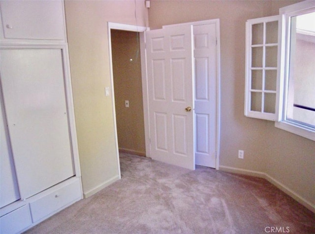 unfurnished bedroom with light colored carpet