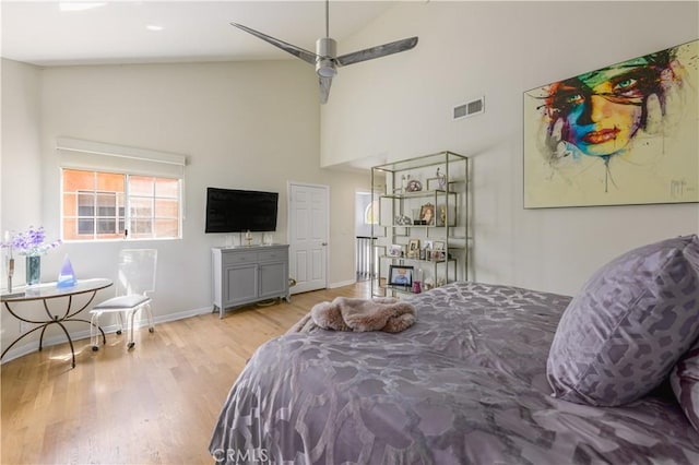 bedroom featuring ceiling fan, high vaulted ceiling, and light wood-type flooring