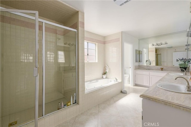 full bathroom with tile patterned floors, plus walk in shower, vanity, and toilet