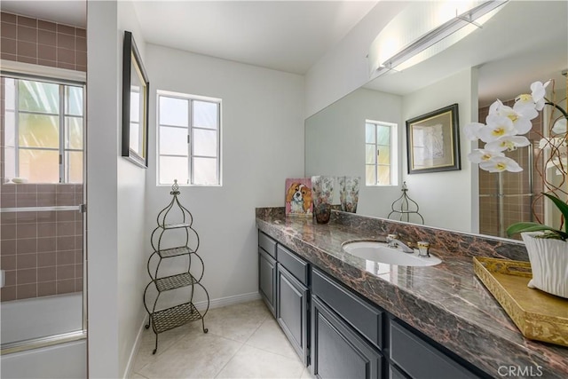 bathroom with vanity, tile patterned floors, and enclosed tub / shower combo