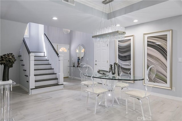 unfurnished dining area featuring light hardwood / wood-style floors and a notable chandelier