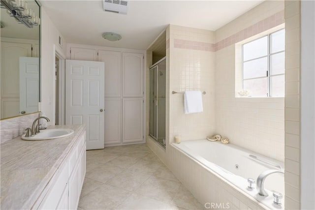 bathroom with tile patterned flooring, vanity, and shower with separate bathtub