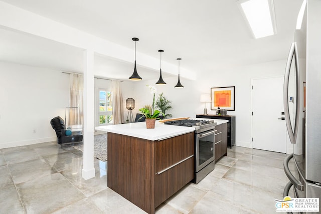 kitchen featuring a kitchen island, decorative light fixtures, and stainless steel appliances