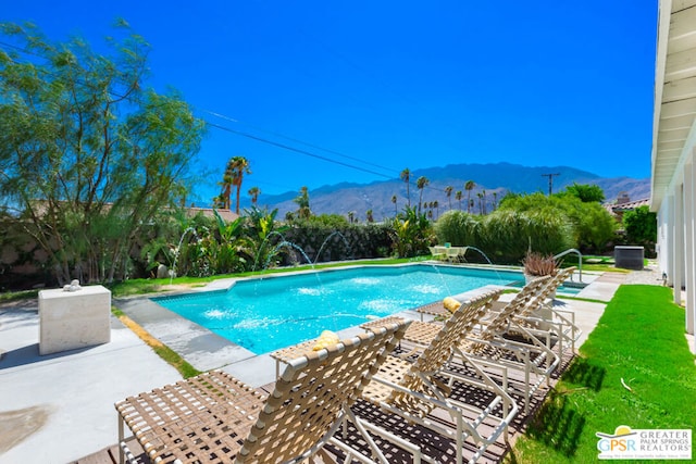 view of swimming pool featuring a patio, a mountain view, and pool water feature