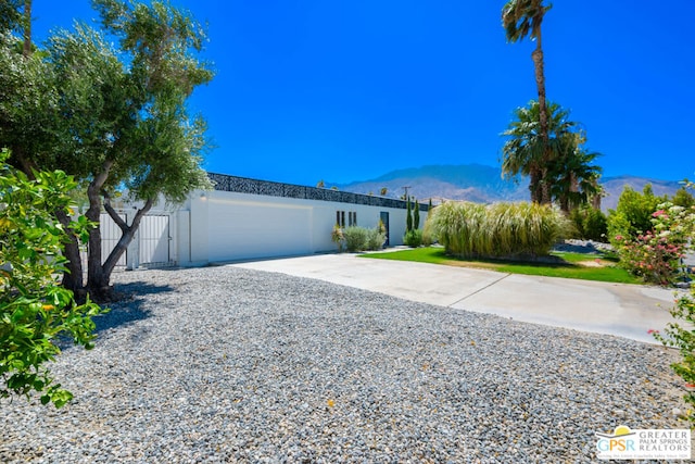 ranch-style house featuring a mountain view and a garage