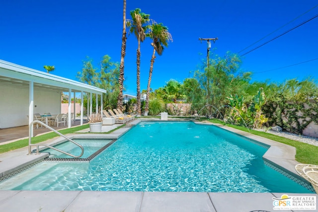 view of pool with an in ground hot tub and a patio